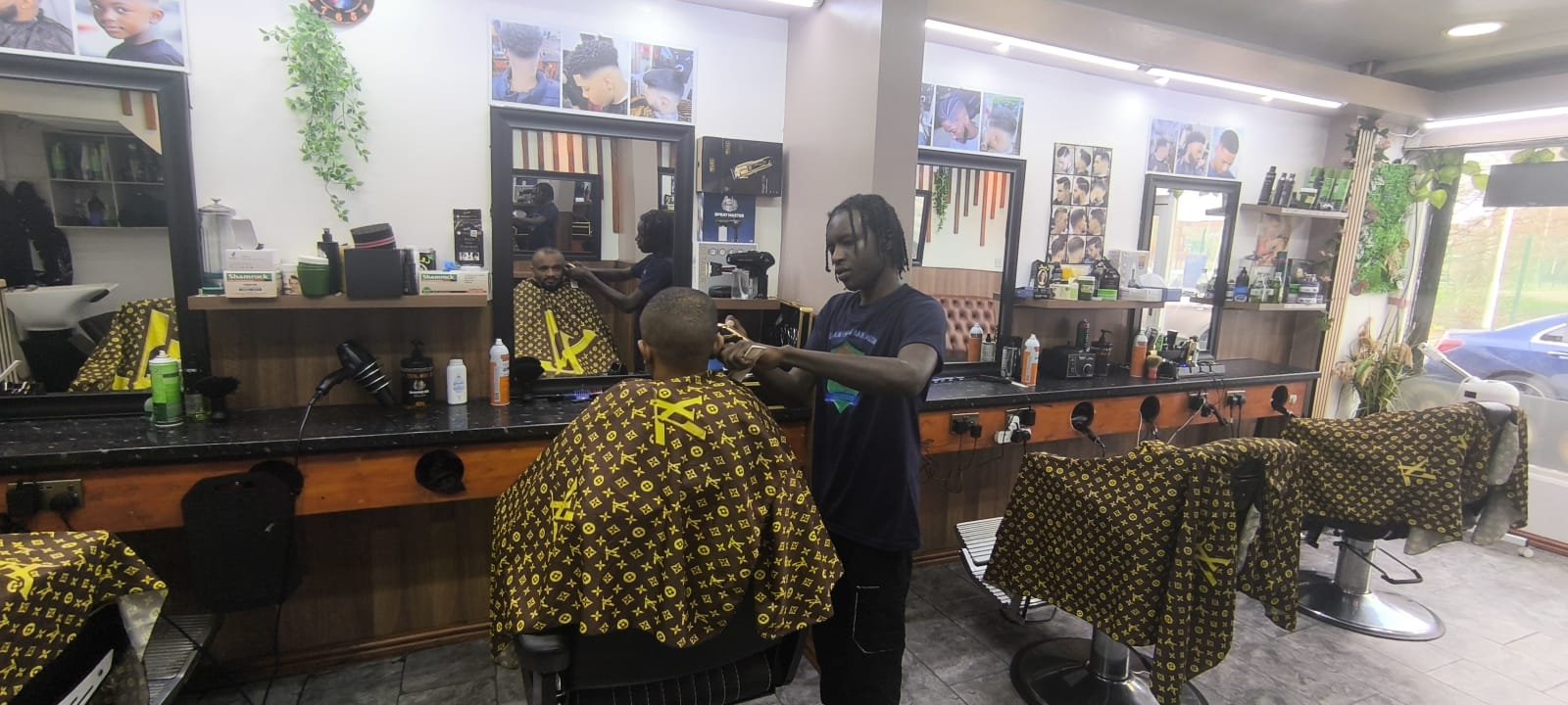 Barber at work at Selam Unisex Hair Salon, Manchester